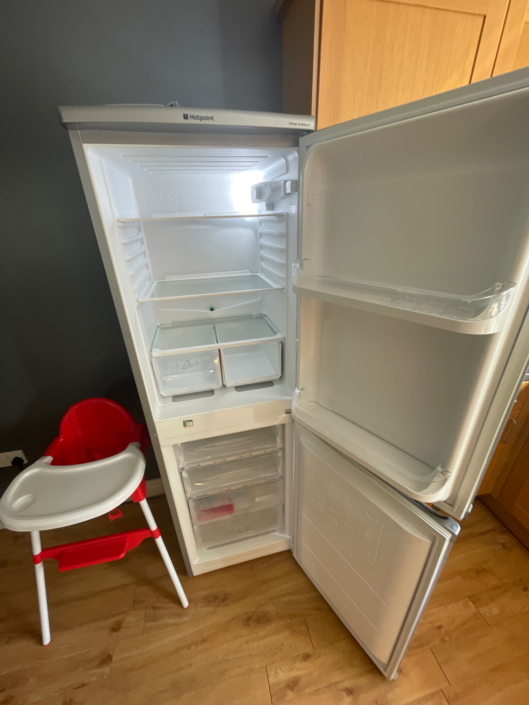 An empty fridge freezer with open doors